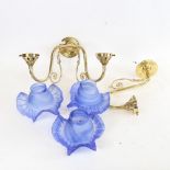 A Christopher Wray brass twin-branch wall light fitting, with frilled blue glass shades, and a