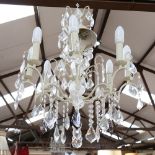 A large distressed wrought-metal 8-branch chandelier, with glass drops, branch length 27cm,