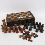 An Indonesian games box, with carved and stained wood Tribal chessmen