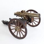 A detailed desktop model of a Gatling field gun, with brass plaque stamped Hartford, Conn, working