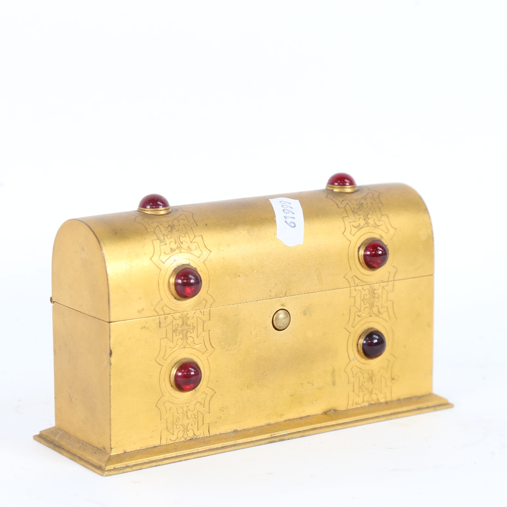 A small Gothic gilt-brass stone set dome-top stationery box, with engraved decoration, W17cm,