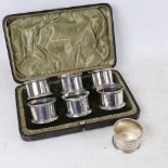 An Edwardian cased set of 6 silver napkin rings, by Walker & Hall, hallmarks Chester 1906, and