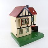 A 1930s Amersham doll's house, with some furniture and electric lights