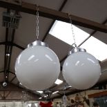 A mid-century pair of milk glass globe and aluminium hanging ceiling lights, shade diameter approx