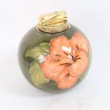 A Moorcroft Hibiscus pattern table lighter, diameter 10.5cm