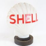 A Vintage Shell Petrol illuminating opaque white glass advertising petrol pump globe lamp, on turned