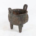 A Chinese cast-iron Archaic style Ding tripod censer, Archaic character mark on base, height 15cm,