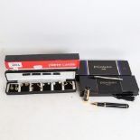 An Yves Saint Laurent Collection black lacquered ballpoint pen, and a set of Pierre Cardin