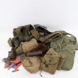 Various American military clothing, including jackets, canvas water bottle holders, utility belts,