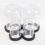 2 pairs of glass domes on mirrored wood bases