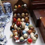 A large quantity of various egg ornaments, including lacquered, china, hardwood, hardstone etc