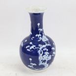 A Chinese blue and white Prunus pattern bottle vase, character mark on base, height 23cm