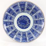 A very large Chinese blue and white charger, allover floral decoration with 6 character mark on