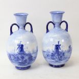 A pair of Doulton Burslem blue and white ceramic vases, Dutch windmill scenes, artist's initials HK,