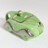 An Art Deco Sadler racing car teapot, circa 1930s, green glaze with silvered detailing, registered