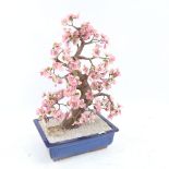 A large scale macket tree in jardiniere, with pink glass petals, height 46cm