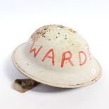 A First World War Period white painted Brodie tin helmet with emblem
