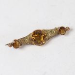 A Victorian unmarked gold and citrine brooch, foliate engraved decoration, brooch length 5cm, 4.9g