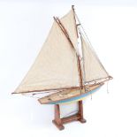 A Vintage tin-hulled Ailsa pond yacht, with sails and rigging, hull length 47cm, with stand