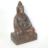 A large Chinese patinated bronze seated Buddha, height 30cm, holes