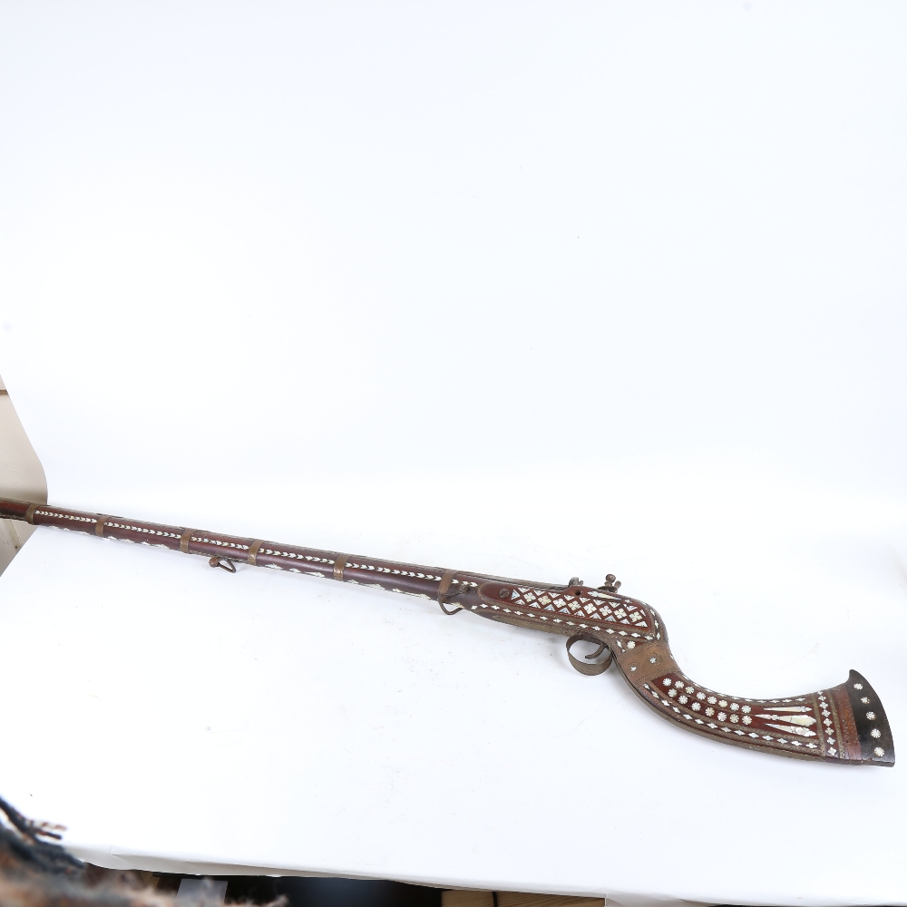 A 19th century Middle Eastern flintlock camel rifle, with allover mother-of-pearl inlaid decoration, - Image 2 of 2