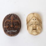 A Japanese carved nut netsuke grotesque mask, signed, and a similar carved bone panel mask,