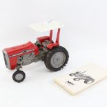 An Ertl & Co Massey Ferguson diesel toy tractor, and a notebook (2)