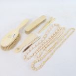 Various ivory items, including 3 strings of ivory beads, and 2 ivory brushes