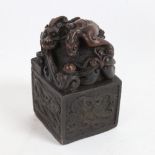 A large Chinese patinated bronze desk seal, dragon decoration, with character mark base, height 13cm