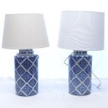 A pair of modern blue and white ceramic table lamps and shades, height including shade 60cm