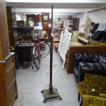 An Antique fluted brass telescopic standard lamp, on stepped plinth base and lion paw feet