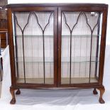 A 1930s mahogany bow-front 2-door display cabinet, W118cm, H126cm, D36cm