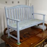 A painted hardwood slatted garden bench, W124cm