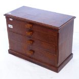 A small teak table-top chest of 4 short drawers, W44cm, H32cm, D22cm