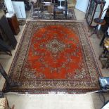 A large red ground Persian design carpet, with symmetrical border and lozenge, 367cm x 274cm