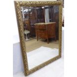 A modern gilt-framed bevel-edge wall mirror, 108cm x 140cm