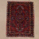 A small red ground Persian mat, 84cm x 63cm