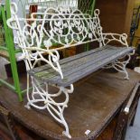 A painted scrolled wrought-iron garden bench, W114cm