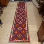 A multi-coloured Kilim runner, 403cm x 81cm