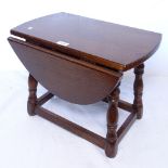 A small oak oval drop leaf swivel-top occasional table, W50cm, H39cm