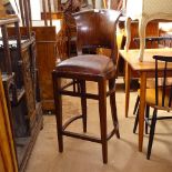 A hardwood and leather-seated bar stool