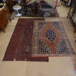 A red ground Afghan rug with symmetrical pattern, 223cm x 129cm, and a red ground Persian design rug