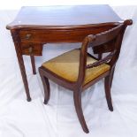 A mahogany bow-front kneehole writing desk, raised on reeded legs, and a Regency mahogany chair,