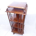 An Edwardian mahogany revolving bookcase, with shaped top, W50cm, H124cm