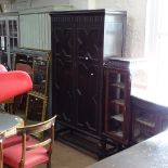 A 1920s oak hall cupboard, with 2 panelled doors, W109cm, H198cm, D44cm