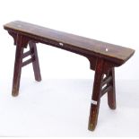 A Chinese stained elm bench stool, L94cm, H52cm