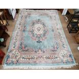 A Chinese cream and blue ground carpet with floral embossed decoration, 366cm x 274cm