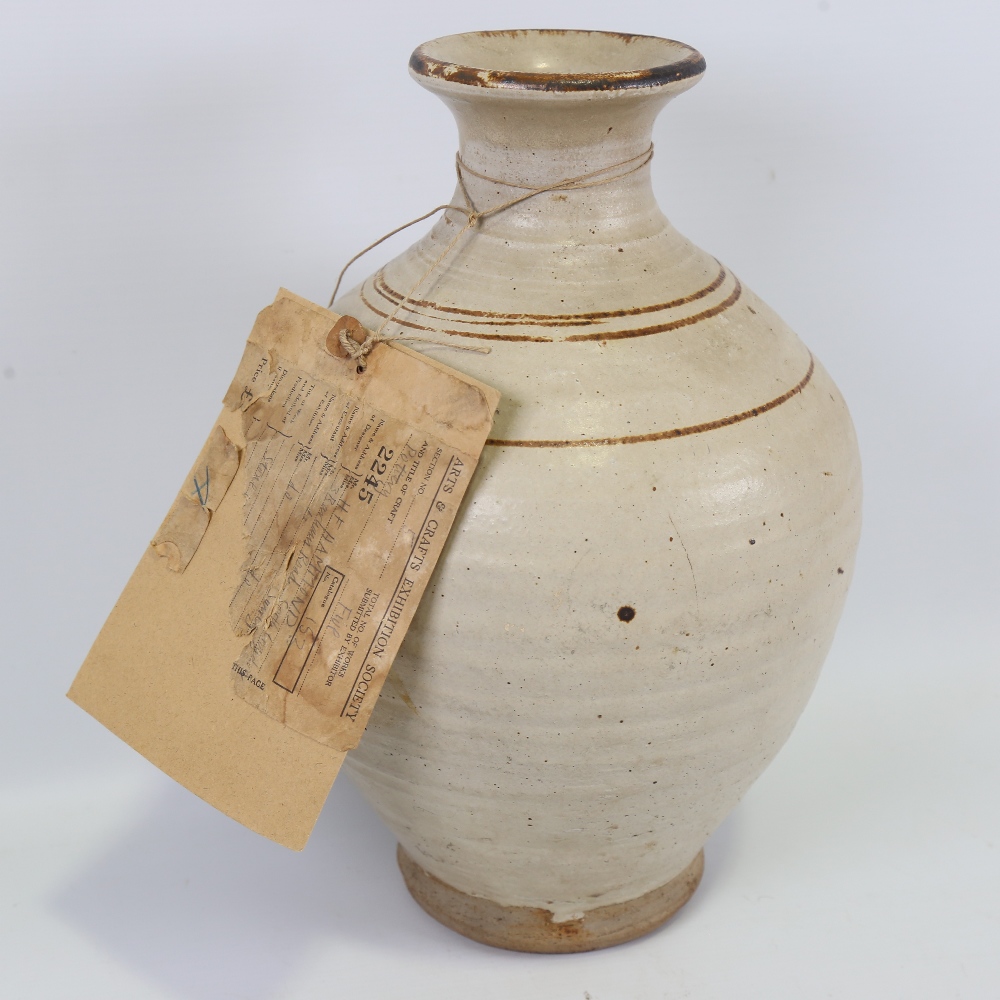HENRY F HAMMOND (1914-88), a stoneware vase with iron banding, with part of purchase label for