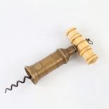 A Victorian patent brass and ivory-handled corkscrew Handle missing the brush, also part of the