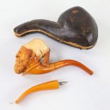 A 19th century carved Meerschaum pipe in the form of an Arab man wearing a Fez, original case with